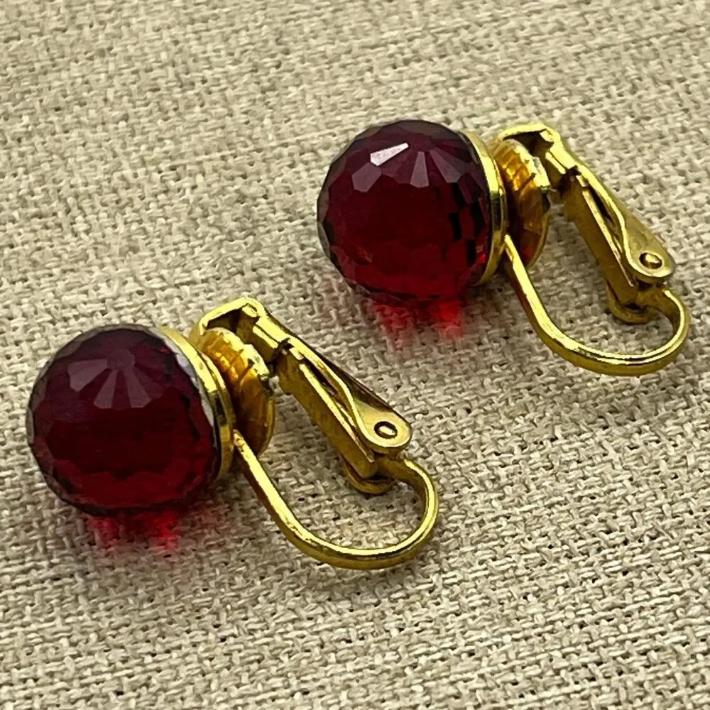 Vintage red glass multi faceted gold tone clip on earrings